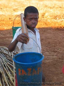 Boy getting water in bucket