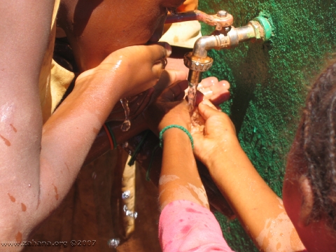 green water faucet with children drinking in madagascar